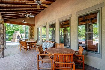 Patio with wooden tables and chairs